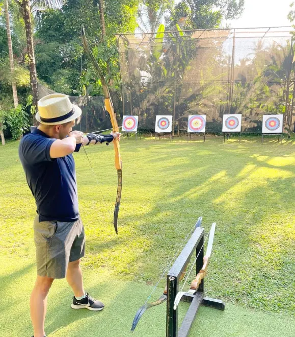 Beginner practicing archery at outdoor adventure zone