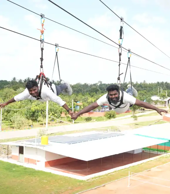 Couple enjoying tandem zipline ride over scenic landscape