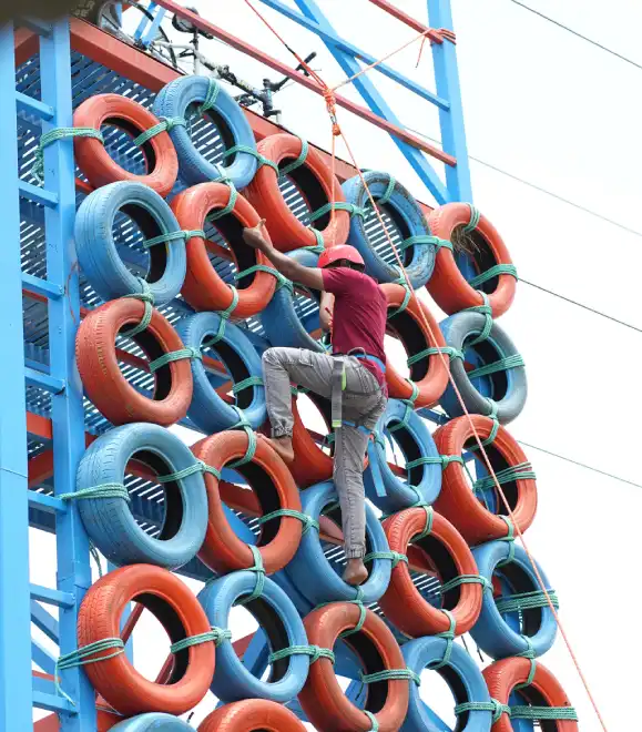 Child enjoying tyre climbing activity at adventure park